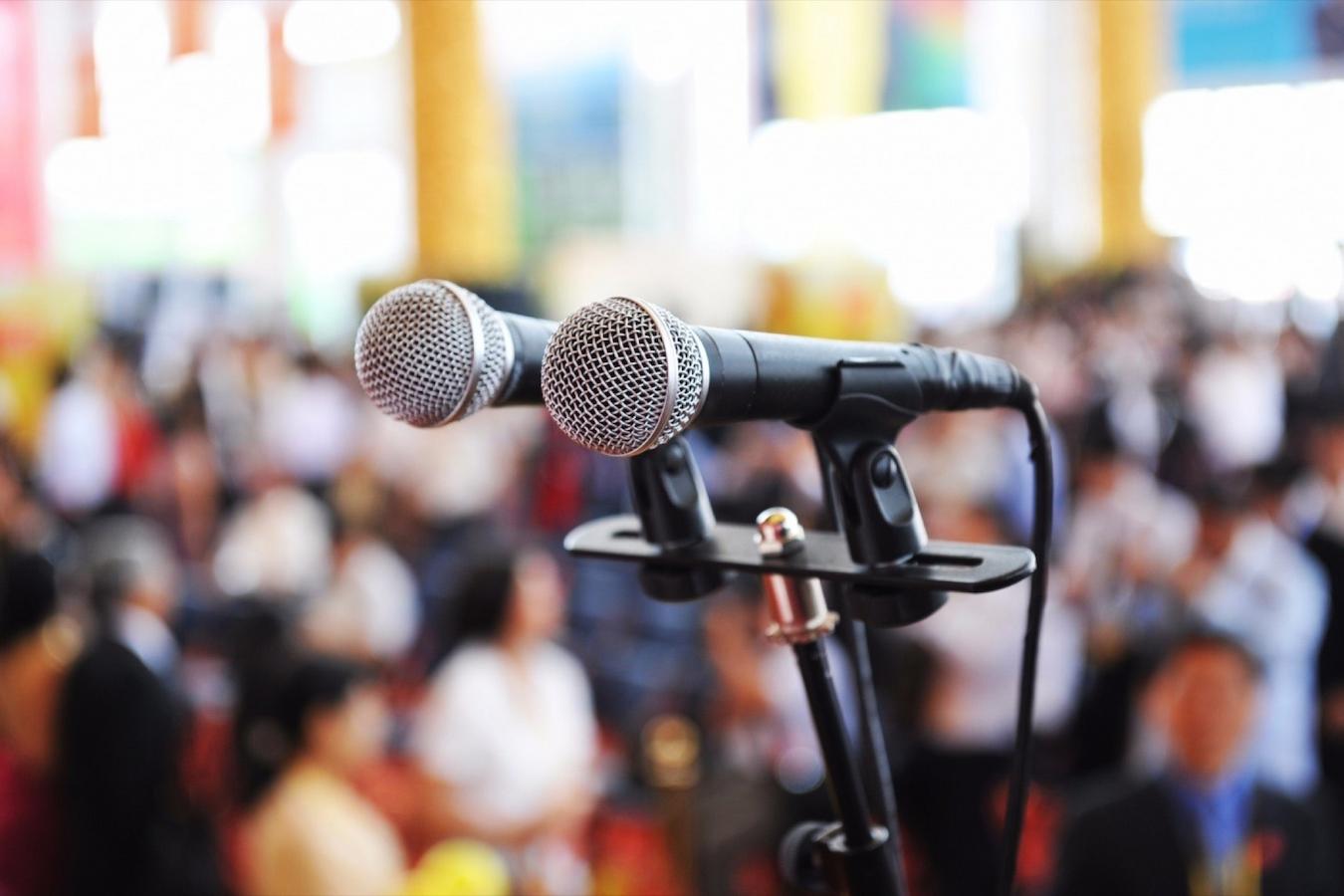 a dual microphone set up at an event directional microphones vocal mic closer headset mic ice cream cone sound engineer lapel mic talk person audio speaking head mouth tips volume point microphone microphones microphone