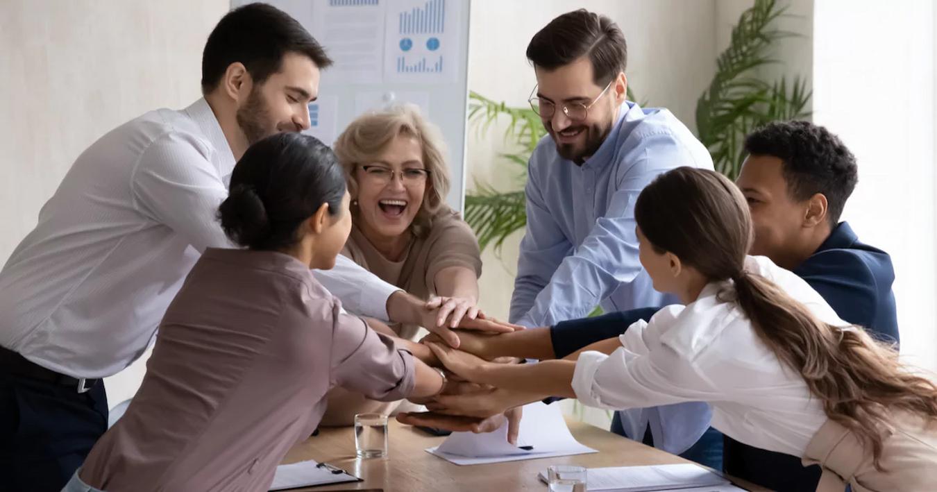 a group of employees high fiving fall team building activities dedicated event manager escape rooms entire group members halloween costumes corn maze delicious cocktails critical thinking virtual activities whole team