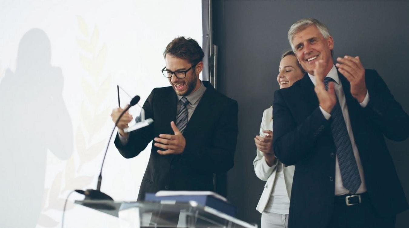 business people laughing and clapping on stage next event team past events similar events cost same page marketing team event checklist future events event checklist