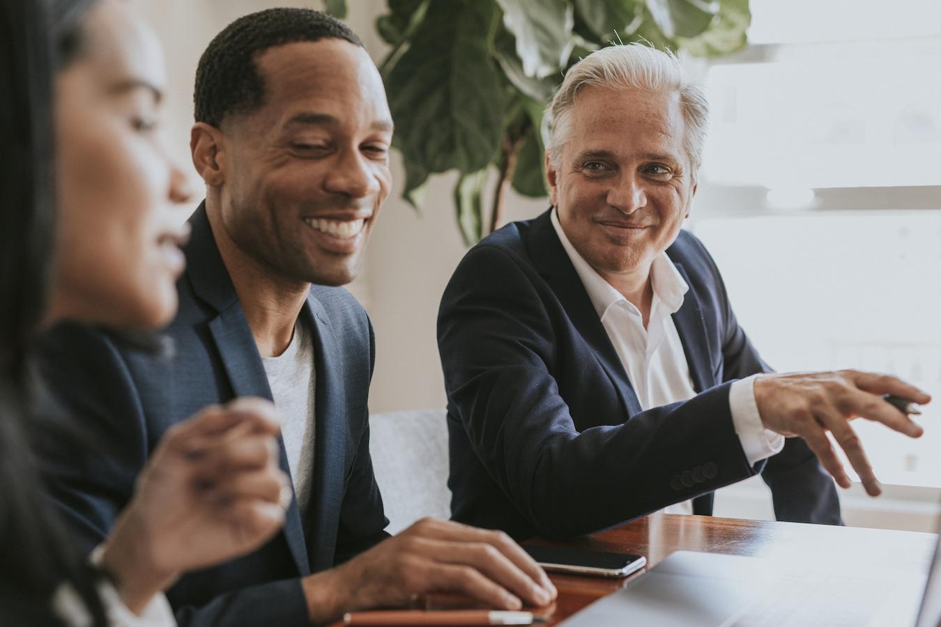 Colleagues smile and discuss how to improve employee engagement