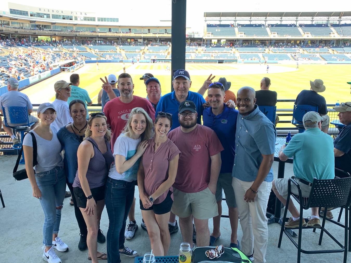 group of people posing for a photo at a baseball game corporate summer outing to a baseball game summer outings summer outings summer outings teams event city group