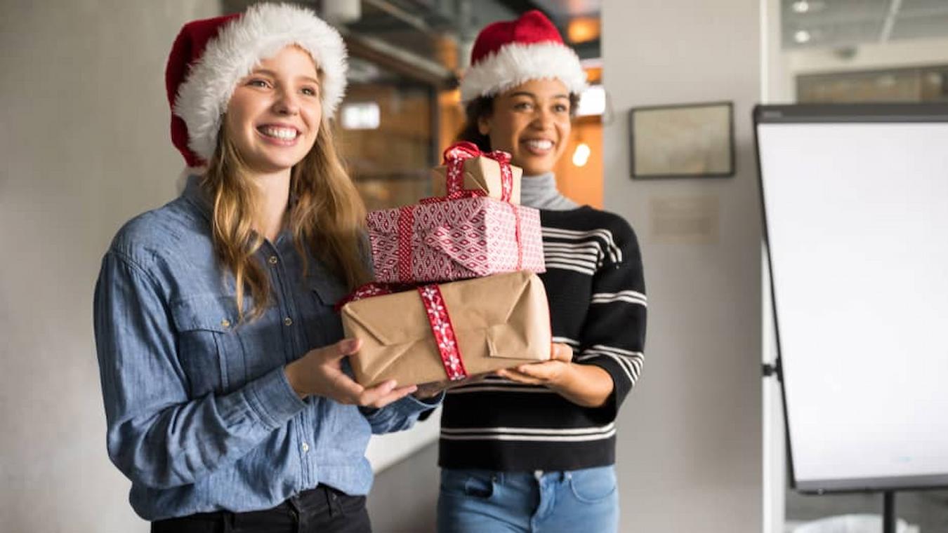 employees bringing Christmas presents to a coworker next team create teams meetings challenges