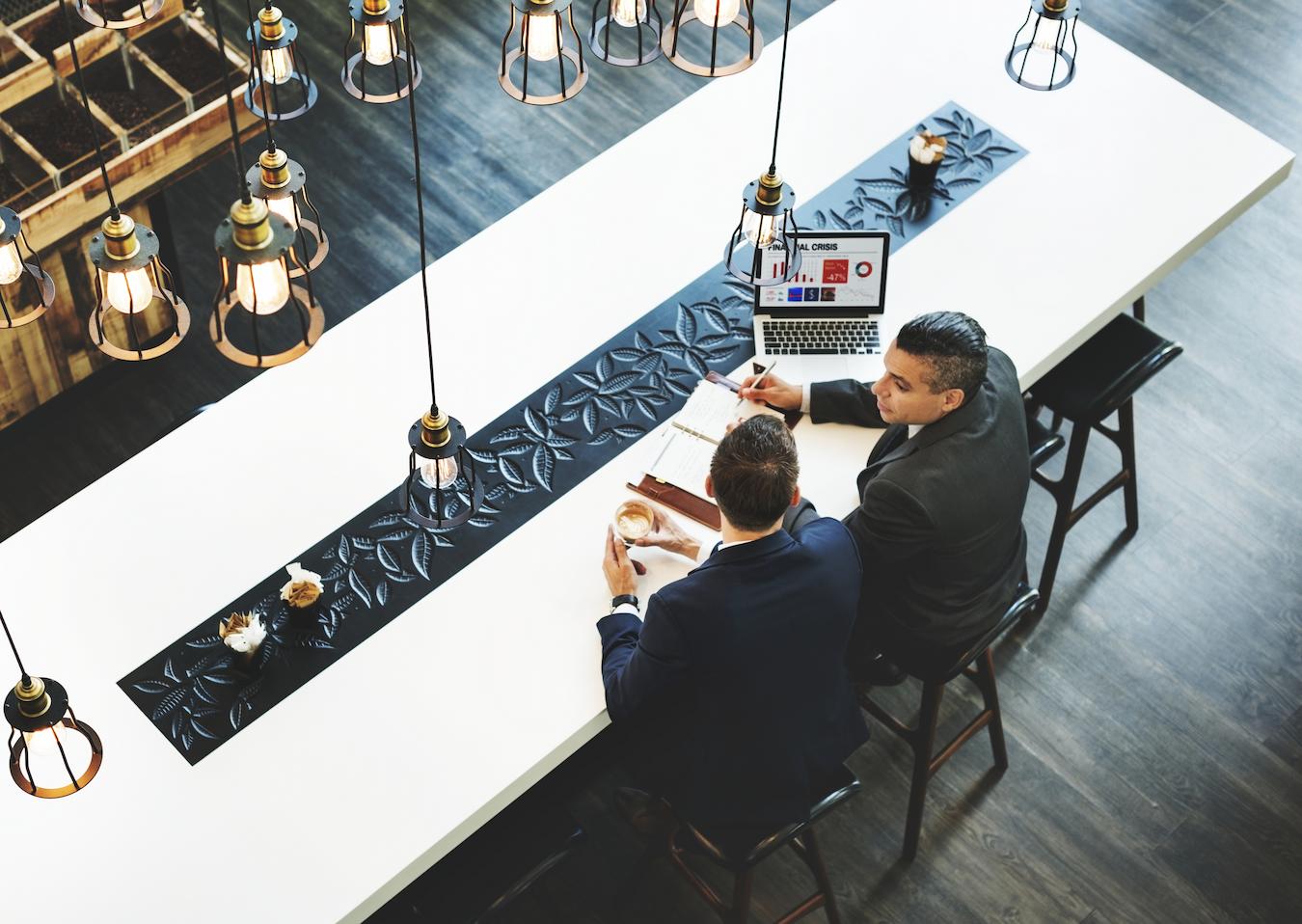 Employees sit in cafe and discuss how to improve employee engagement