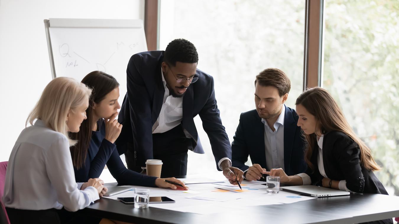 Five colleagues review all the information in the meeting minutes