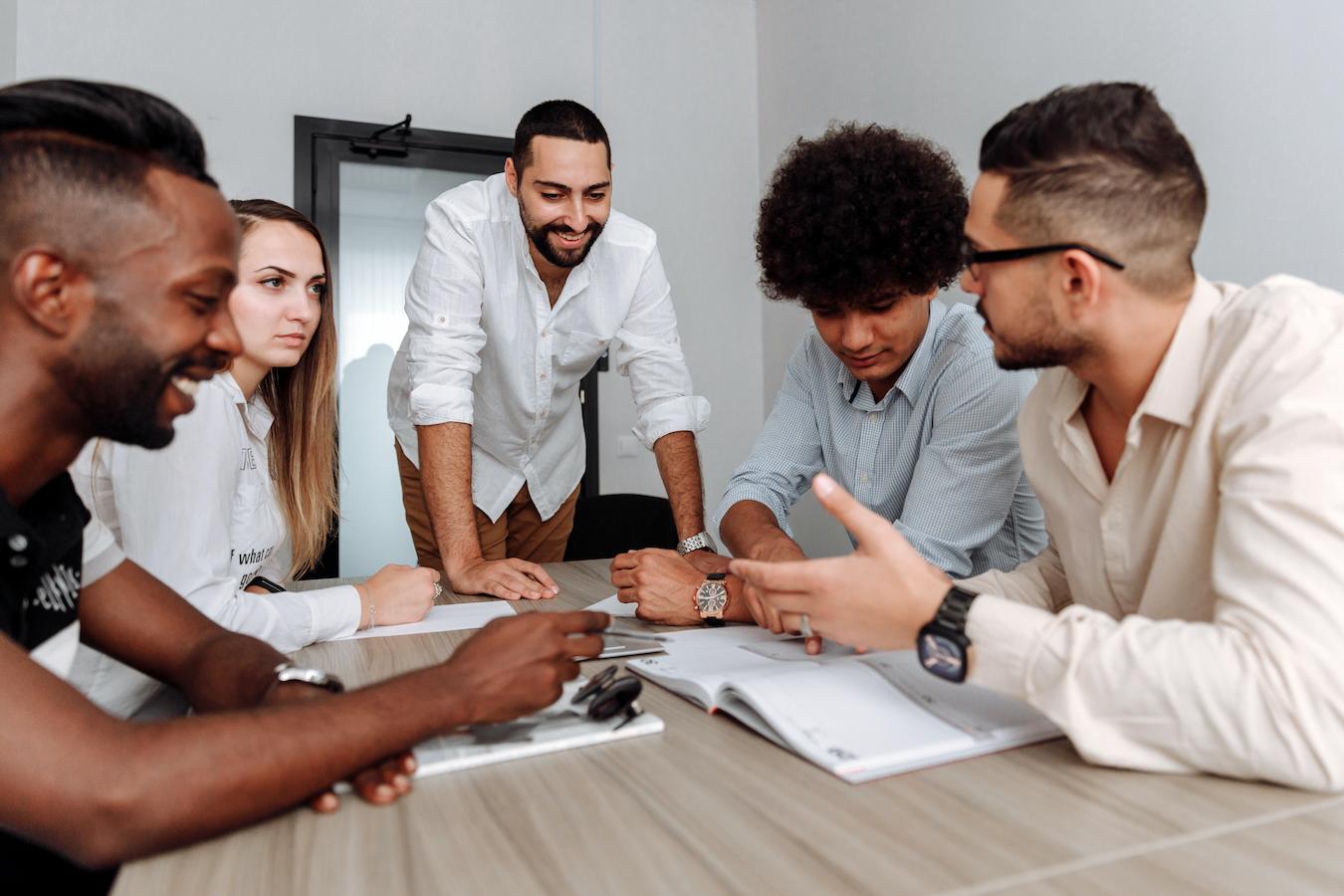 Five colleagues sit around table to discuss amendments to company values