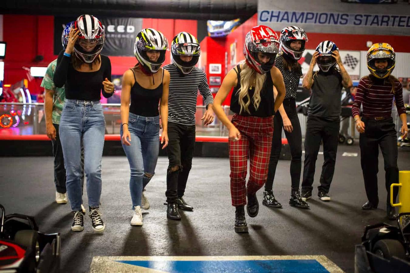 friends wearing helmets before go karting fun summer team building outdoor team building activities team member team's interests fun summer team building