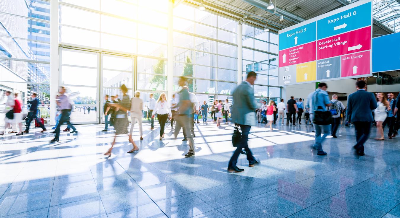Guests with cash prepare to advance to new booths to create more connections