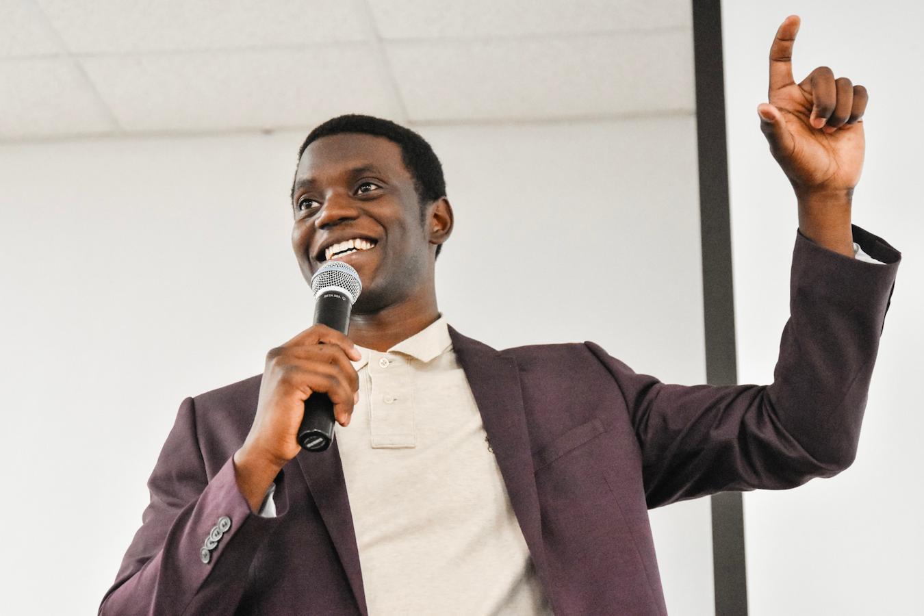 man speaking into a microphone next event management show document color coding makes sense