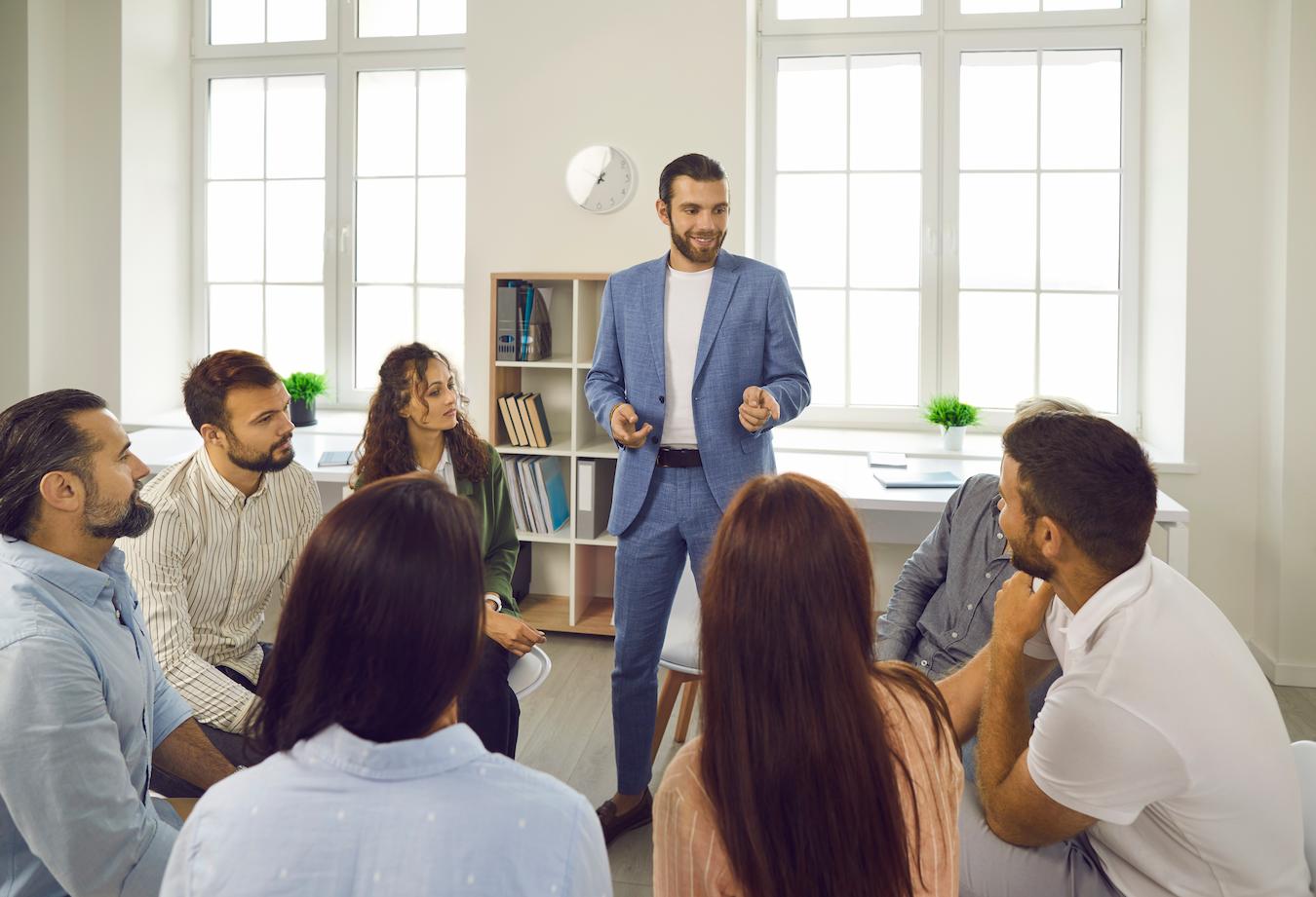 Office group discuss social media engagement and adding more pages to company website
