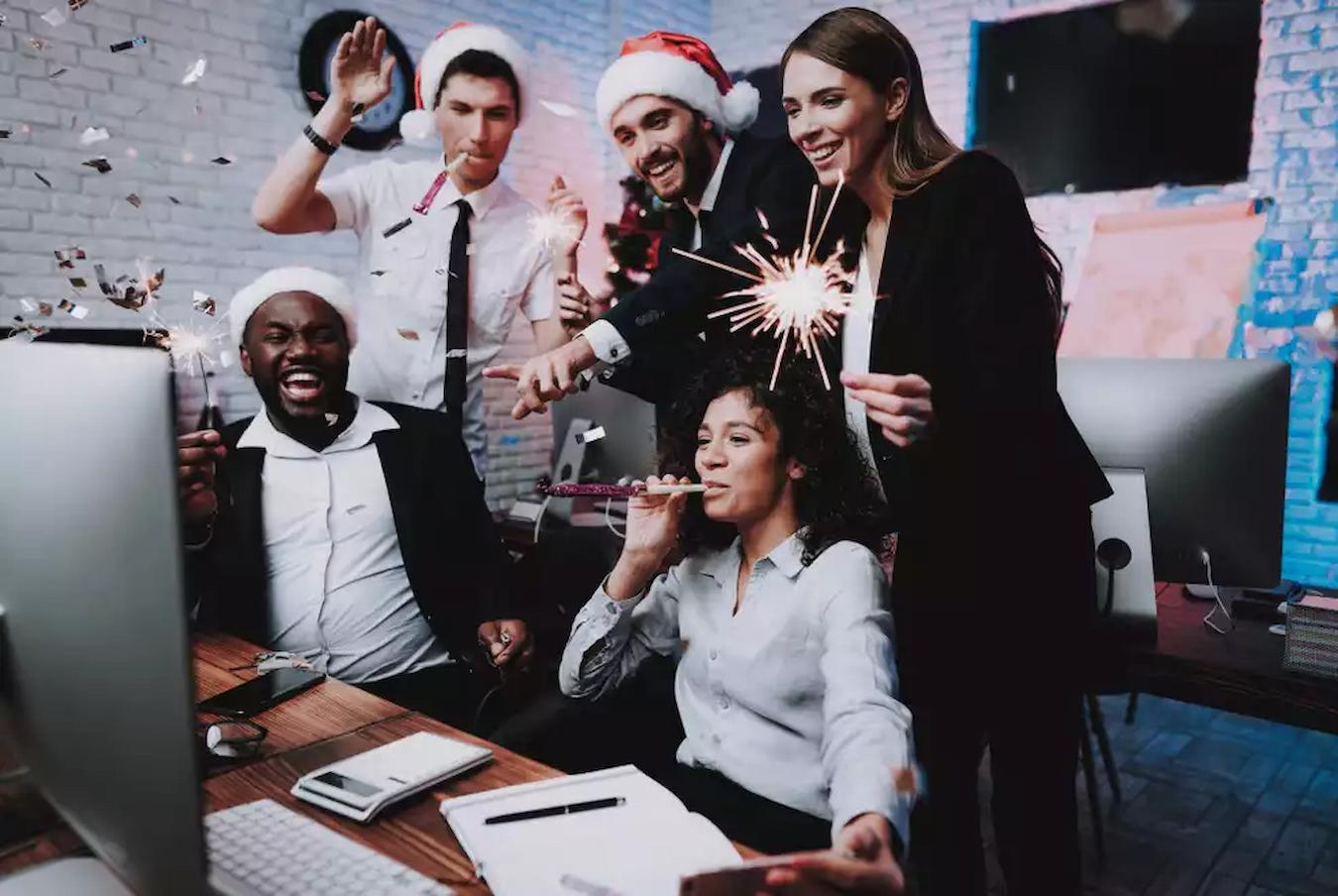 people celebrating at work company's holiday party ideas secret santa wine tasting award prizes low key groups conference room virtual reality photo booth