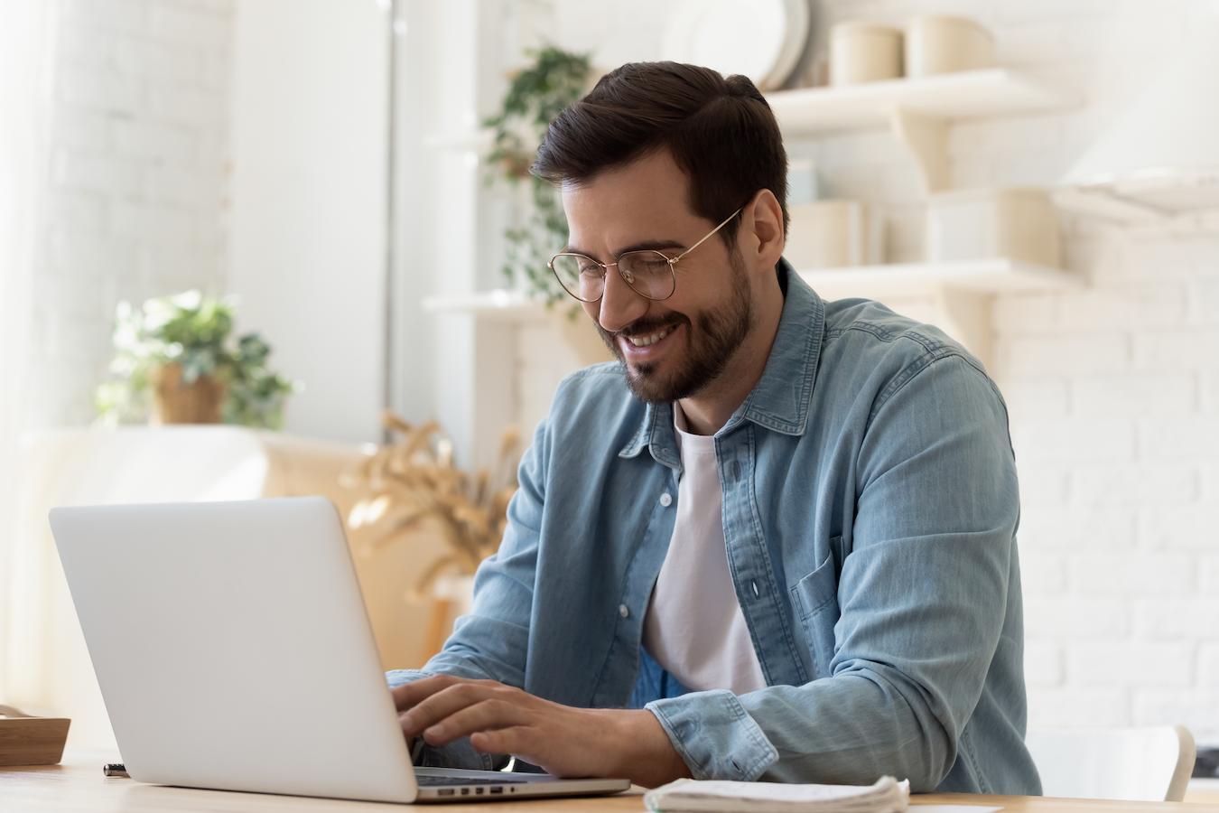 Person in white shirt and blue button down reviews team meeting agenda examples to set the stage for effective meetings