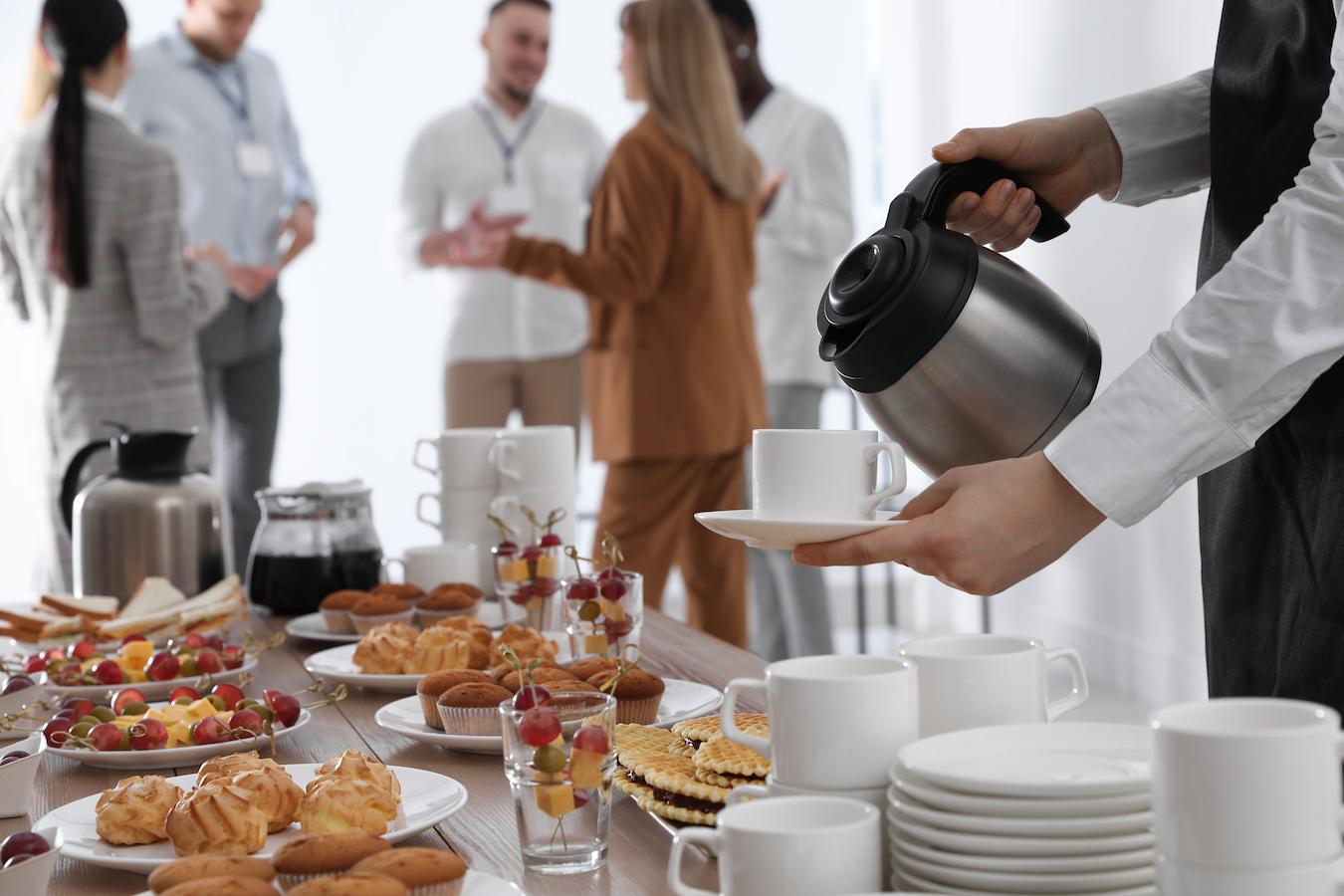 Person pours coffee at company breakfast