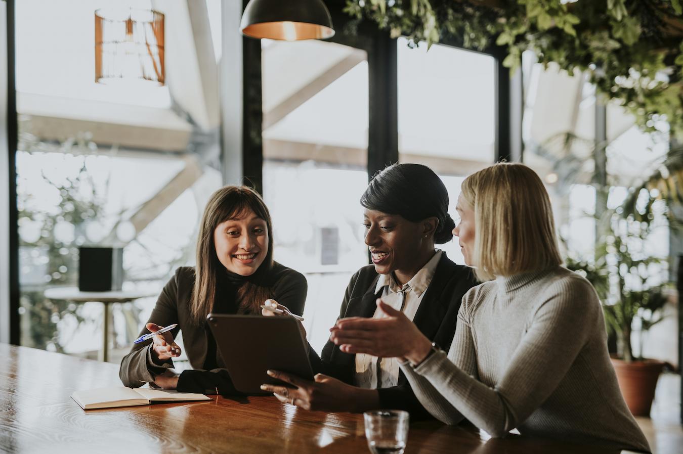 Three coworkers brainstorm an idea together